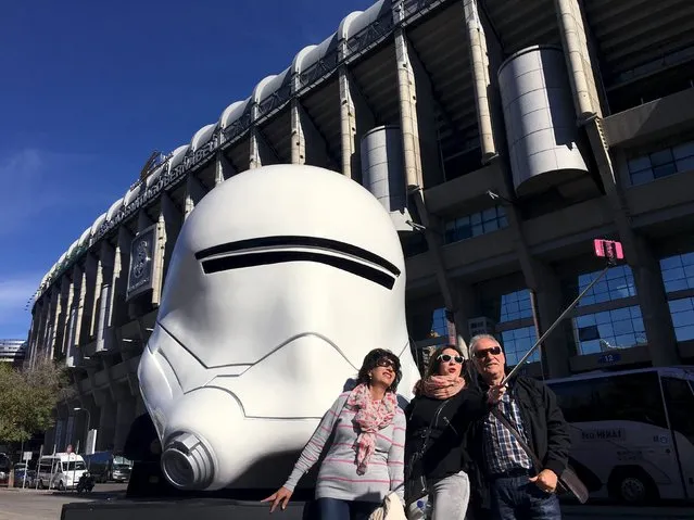 Local tourists take a selfie with a Storm Trooper mask outside Santiago Bernabeu Stadium in Madrid, Spain, November 18, 2015. (Photo by Juan Medina/Reuters)