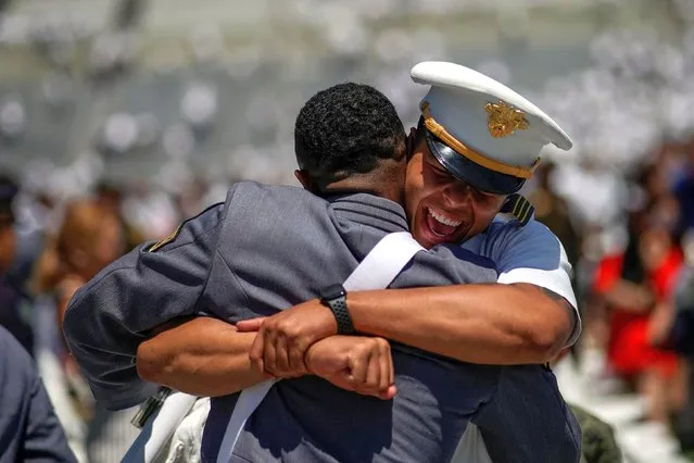 Graduation cadets congratulate each other at the end of the 2023 graduation ceremony at the United States Military Academy (USMA), at Michie Stadium in West Point, New York, U.S., May 27, 2023. (Photo by Eduardo Munoz/Reuters)