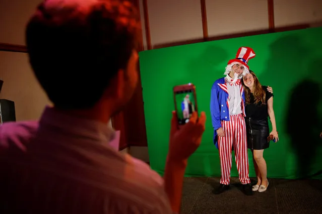 A woman gets her picture taken with a man dressed as Uncle Sam in a U.S. presidential elections night event held by the U.S. Embassy in Tel Aviv, Israel November 8, 2016. (Photo by Baz Ratner/Reuters)