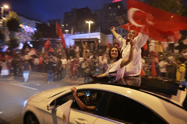 Supporters of Turkey's President and ruling Justice and Development Party, or AKP, leader Recep Tayyip Erdogan celebrate outside the party headquarters in Istanbul, Sunday, June 24, 2018. Unofficial results from Turkey's presidential election show incumbent Recep Tayyip Erdogan with a commanding lead. (Photo by Emrah Gurel/AP Photo)