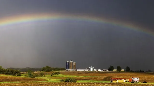 A rainbow appears behind a storm that prompted a tornado warning in the area south of Johnson, Neb. on Friday, May 12, 2023. (Photo by Chris Machian/Omaha World-Herald via AP Photo)