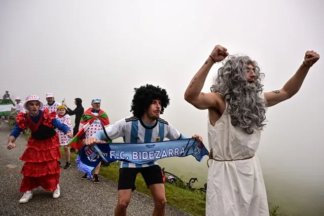 Spectators in costum cheer along the roadside of the ascent of Col de Soudet during the 5th stage of the 110th edition of the Tour de France cycling race, 163 km between Pau and Laruns, in the Pyrenees mountains in southwestern France, on July 5, 2023. (Photo by Marco Bertorello/AFP Photo)