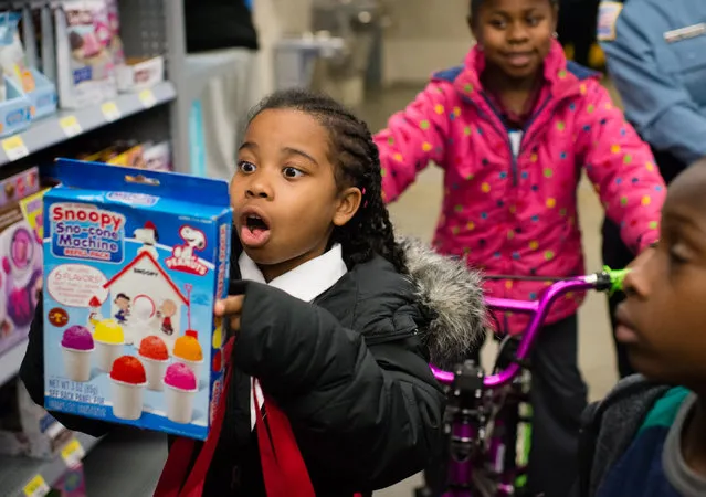 Haleigh Holman, 7, looks at a snoopy snow cone machine toy. The Metropolitan Police Department teamed up with Walmart for the annual Shop with a Cop shopping event on December 10, 2015 at Walmart's Fort Totten Store in Washington, DC. (Photo by Sarah L. Voisin/The Washington Post)