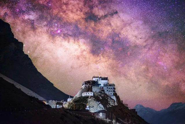 Key Monastery illuminated on a mountain in the Spiti Valley, Himachal Pradesh, northern India with an amazing nights sky illuminated beyond. (Photo by Grey Chow/Caters News Agency)