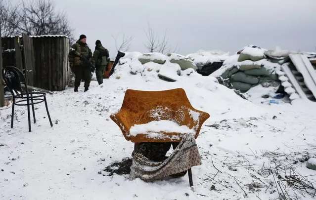 Pro-Russian separatists stand behind an armchair at a checkpoint used by Ukrainian government troops on the outskirts of Vuhlehirsk, eastern Ukraine February 10, 2015. (Photo by Maxim Shemetov/Reuters)