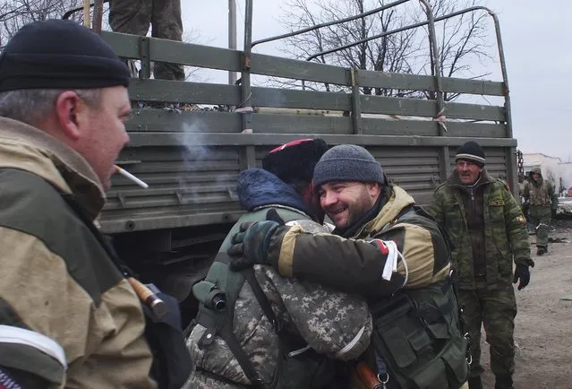 A pro-Russian rebel cossack, second left, hugs another rebel in Debaltseve, eastern Ukraine, Thursday, February 19, 2015. (Photo by Peter Leonard/AP Photo)