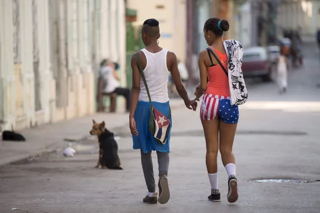 A couple who did not give their names walk in downtown Havana, February 2, 2015. (Photo by Alexandre Meneghini/Reuters)