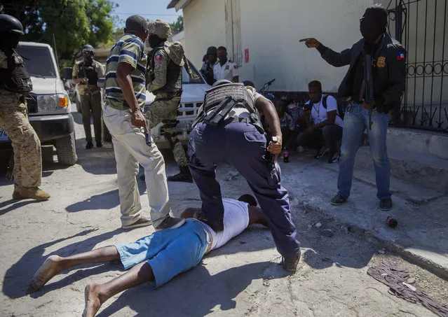 An inmate is recaptured outside the Croix-des-Bouquets Civil Prison after an attempted breakout, in Port-au-Prince, Haiti, Thursday, February 25, 2021. (Photo by Dieu Nalio Chery/AP Photo)