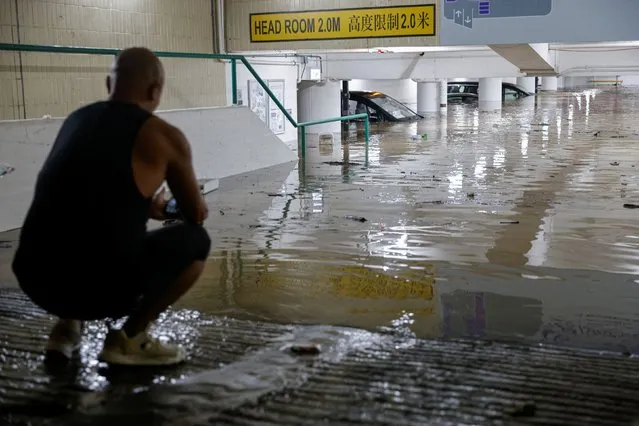 Vehicles are seen at a flooded packing lot during heavy rain, in Hong Kong, China on September 8, 2023. (Photo by Tyrone Siu/Reuters)