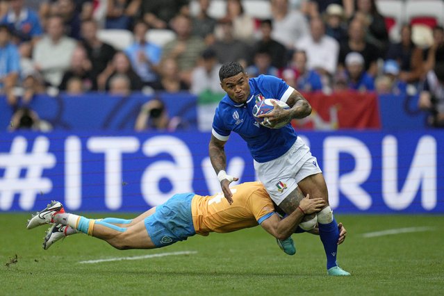 Italy's Montanna Ioane is tackled by Uruguay's Gaston Mieres during the Rugby World Cup Pool A match between Italy and Uruguay at the Stade de Nice, in Nice, Wednesday, September 20, 2023. (Photo by Daniel Cole/AP Photo)