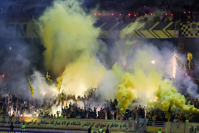 Fans of Sepahan light flares and smoke in the stands after their AFC Champions League group stage soccer match against Al-Ittihad was cancelled, in Isfahan, Iran, 02 October 2023. The match of Iranian side Sepahan against Saudi side Al-Ittihad was “cancelled due to unanticipated and unforeseen circumstances”, an AFC statement reads, after Ittihad players refused to play. (Photo by Peyman Shahsanaei/EPA/EFE)