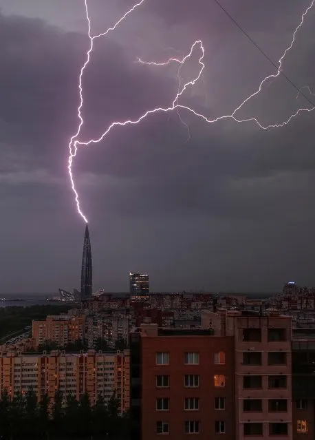 Lightning strikes are seen above the business tower Lakhta Centre, which is under construction in Saint Petersburg, Russia on May 18, 2021. (Photo by Anton Vaganov/Reuters)