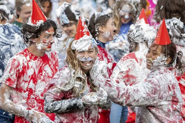 Students take part in the traditional Raisin Monday foam fight on St Salvator's Lower College Lawn at the University of St Andrews, Scotland, Monday, October 16, 2023. The messy display is the culmination of a weekend of festivities where first years say thank you to their more senior student “parents” for mentoring them. (Phoot by Lesley Martin/PA Wire via AP Photo)