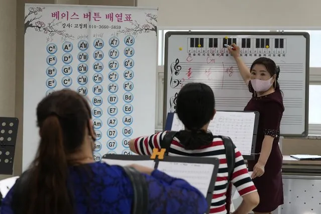 Ko Jeong Hee, right, a defector who teaches accordion, gives a lecture during the accordion class at the Inter-Korean Cultural Integration Center in Seoul, South Korea, on June 10, 2021. The center, which opened last year, is South Korea’s first government-run facility to bring together North Korean defectors and local residents to get to know each other through cultural activities and fun. It’s meant to support defectors’ often difficult resettlement in the South, but also aims at studying the possible blending of the rivals’ cultures should they unify. (Photo by Ahn Young-joon/AP Photo)