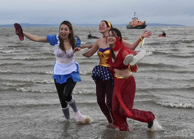 Swimmers in fancy costume take part in the New Year's Day swim at Saundersfoot in Wales, Britain, January 1, 2017. (Photo by Rebecca Naden/Reuters)