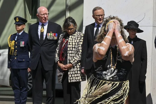 An indigenous dancer performs as Governor-General David Hurley, second left, and Prime Minister Anthony Albanese watch at the Proclamation of King Charles III, on the forecourt of Parliament House, in Canberra, Sunday, September 11, 2022. The monarch's representative in Australia will proclaim the ascension of King Charles III as mourning continues around the nation for Queen Elizabeth II who died on Sept. 8, 2022. She was 96. (Photo by Mick Tsikas/AAP Image)