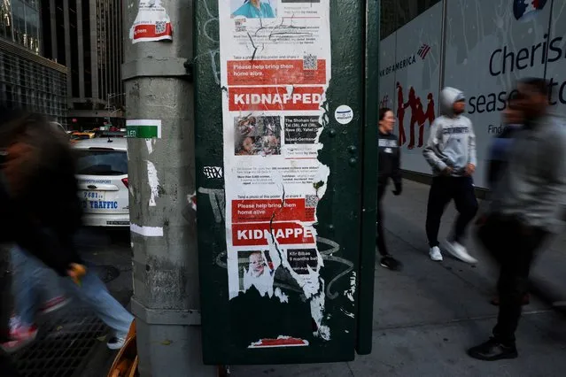 Partly torn posters featuring pictures with the word “kidnapped” hang, amid the ongoing conflict between Israel and the Palestinian Islamist group Hamas, on a pole at the Midtown section of New York City on November 29, 2023. (Photo by Shannon Stapleton/Reuters)