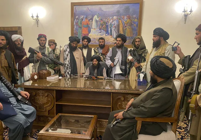 Taliban fighters take control of Afghan presidential palace after the Afghan President Ashraf Ghani fled the country, in Kabul, Afghanistan, Sunday, August 15, 2021. (Photo by Zabi Karimi/AP Photo)