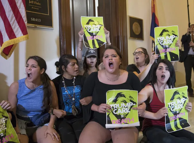 In this July 10, 2017, file photo, activists protest against the Republican health care bill outside the offices of Sen. Jeff Flake, R-Ariz., and Sen. Ted Cruz, R-Texas on Capitol Hill in Washington. About 120,000 Arizona residents who receive Medicaid benefits will have to get a job, do community service or temporarily lose health coverage. The Centers for Medicare and Medicaid Services approved the state's plan Friday, Jan.18, 2019. The Trump administration has urged states to consider changes to their Medicaid programs to encourage work and independence. Others say it unfairly targets the working class. (Photo by J. Scott Applewhite/AP Photo)