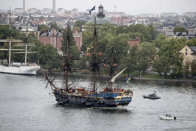A full-size replica of a 18th century, three-mast, ocean-going wooden tall galleon that sank in 1745, enters Stockholm on Thursday, August 26, 2021 on its first stop on its second journey to Asia that the ship will make next year. In 1745, the original merchant ship that had more than 130 men on board, ran aground and sank outside her home port of Goteborg, Sweden’s second largest city, as it approached the harbor as it returned from its third voyage to China. (Photo by Christine Olsson/TT News Agency via AP Photo)