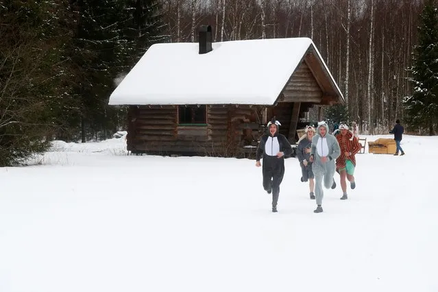 People run during the sauna marathon near Otepaa, Estonia on February 2, 2019. Participants have to track down, locate and visit designated saunas in the Otepaa area as fast as possible during the event. The team that completed all of the saunas in the shortest time wins. (Photo by Ints Kalnins/Reuters)
