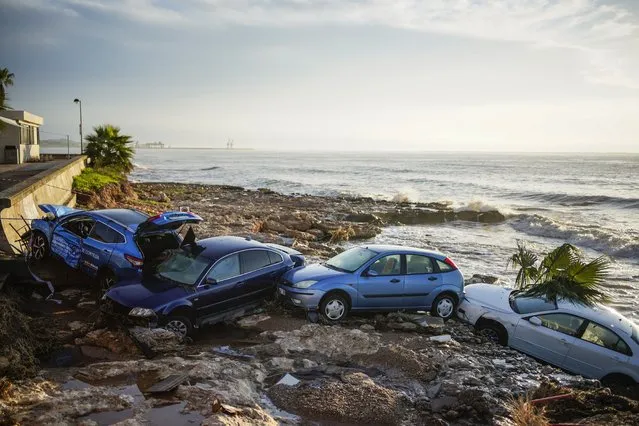 Wrecked cars stuck in the shore of the seaside town of Alcanar, in northeastern Spain, Thursday, September 2, 2021. A downpour Wednesday created flash floods that swept cars down streets in the Catalan town of Alcanar. Most of mainland Spain is under alert for heavy rains. (Photo by Joan Mateu Parra/AP Photo)