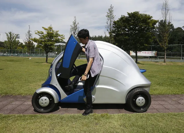 A researcher gets out of “Armadillo-T”, a foldable electric vehicle, at the Korea Advanced Institute of Science and Technology in Daejeon, South Korea Wednesday, September 4, 2013. (Photo by Kim Hong-Ji/Reuters)