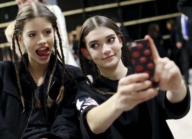 A model uses her phone with a friend backstage of the Aquilano Rimondi Autumn/Winter 2016 woman collection during Milan Fashion Week, Italy, February 27, 2016. (Photo by Alessandro Garofalo/Reuters)