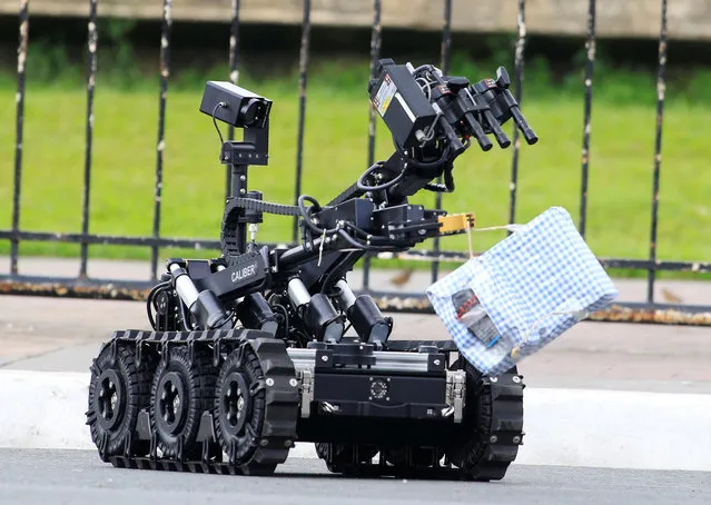 Members of the Philippine National Police (PNP) Explosives Ordinance Division, deploy an ICOR MK3 Caliber robot to neutralize an improvised explosive device during a bomb disposal exercise along a main street in metro Manila, Philippines February 10, 2017. (Photo by Romeo Ranoco/Reuters)