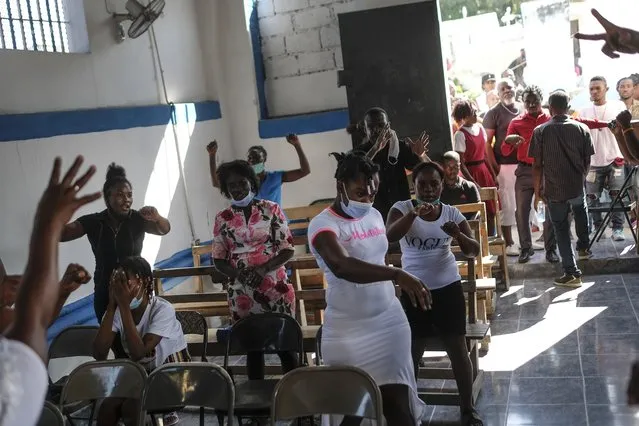 People gather inside a church on the Fete Gede celebration of spirits Vodou holiday at the National Cemetery in Port-au-Prince, Haiti, Monday, November 1 2021. (Photo by Matias Delacroix/AP Photo)