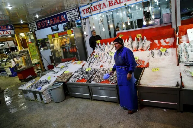 A fish market worker waits for customers at Sakarya Street in Ankara, Turkey, March 15, 2016. (Photo by Umit Bektas/Reuters)