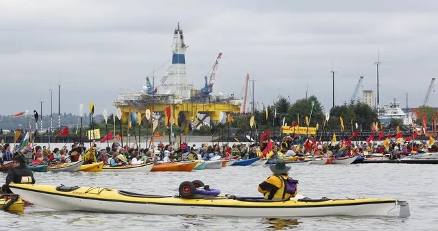 Activists protest the Shell Oil Company's drilling rig Polar Pioneer which is parked at Terminal 5 at the Port of Seattle, Washington May 16, 2015. (Photo by Jason Redmond/Reuters)