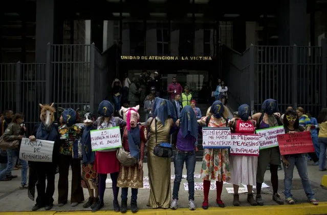 A group of women wearing masks a protest against violence against women outside of the General Prosecutor's Office in Caracas, Venezuela, Wednesday, March 8, 2017. Thousands of women are marching to commemorate International Women’s Day around the world. (Photo by Ariana Cubillos/AP Photo)