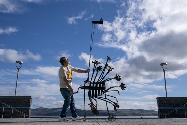 Artist and general manager Willie Sutherland with “Machine For Applauding Paintings (with Critic's Thumb Attachment)” during a photocall for The Wyllieum, a new gallery dedicated to George Wyllie in Greenock, UK on Thursday, April 25, 2024. (Photo by Jane Barlow/PA Images via Getty Images)