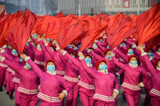 In this picture taken on January 5, 2022, people take part in a demonstration march after the Pyongyang City rally to carry out the decision of the 4th Plenary Meeting of the 8th Central Committee of the Workers' Party of Korea, at Kim Il Sung Square in Pyongyang. (Photo by Kim Won Jin/AFP Photo)
