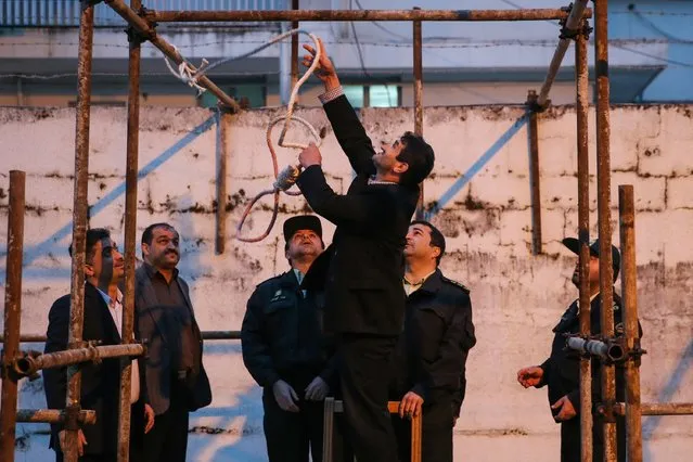 Officials prepare the noose for the execution of Balal, who killed an Iranian youth Abdolah Hosseinzadeh in a street fight with a knife in 2007, during his execution ceremony in the northern city of Nowshahr on April 15, 2014. Samereh Alinejad, the mother of  Abdolah Hosseinzadeh, spared the life of Balal, her son's convicted murderer, with an emotional slap in the face as he awaited execution prior to removing the noose around his neck with the help of her husband. (Photo by Araash Khamooshi/AFP Photo/ISNA)