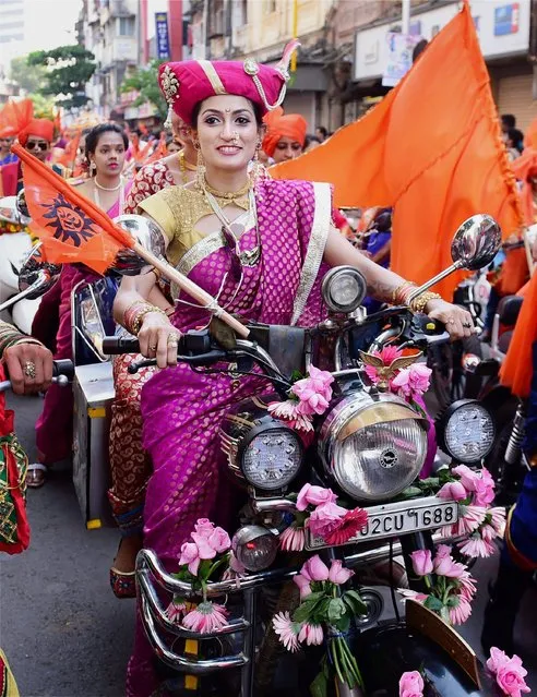 A woman decked up in traditional attire,  participate in a community parade (“Shobha Yatra”) to celebrate the Maharashtrian new year “Gudi Padwa”, in Mumbai , India on Tuesday, March 28, 2017. (Photo by Press Trust of India)