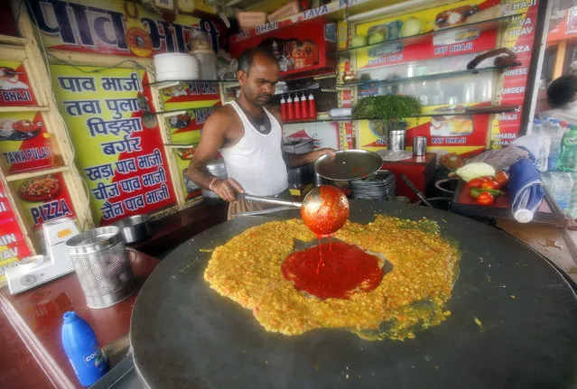 A cook prepares local cuisine, Pav Bhaji, at a beachside restaurant in Mumbai June 24, 2010. (Photo by Danish Siddiqui/Reuters)