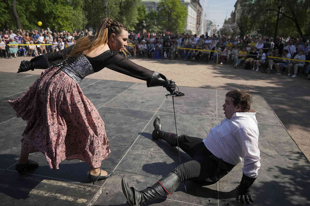 Participants of a fencing show fight during celebrations of the 321st anniversary of St. Petersburg, in St. Petersburg, Russia, Sunday, May 26, 2024. (Photo by Dmitri Lovetsky/AP Photo)