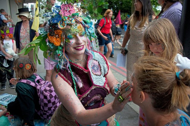 Demonstrators with an glittery outfits, elaborate animal costumes and intricate face paint takes part in the “Restore Nature Now” protest supported by Extinction Rebellion (XR), National Trust and WWF in London on June 22, 2024. (Photo by Sophia Evans/The Observer)