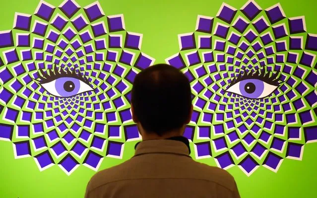A man stands in front of a optical illusions picture during the press preview of the interactive experience exhibition “Tricked! – The spectacular illusion exhibition” at Augustusburg castle in Augustusburg, Germany, Tuesday, October 1, 2019. The show, which presents paintings by Mexican artist Yunuen Esparza, deals with the functioning of the eye, the laws of optics and the interconnection of the senses in the brain. The exhibition starts on Oct. 5, 2019. (Photo by Jens Meyer/AP Photo)