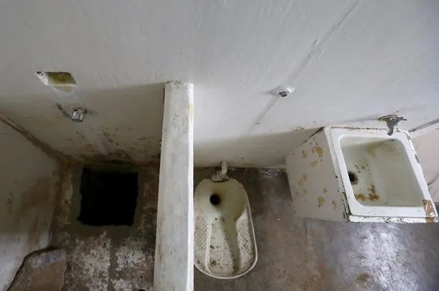 A view of the opening of a tunnel (L), which is connected to a warehouse, and the toilet area inside drug lord Joaquin “El Chapo” Guzman's cell in the Altiplano Federal Penitentiary, where he escaped from, in Almoloya de Juarez, on the outskirts of Mexico City, July 15, 2015. (Photo by Edgard Garrido/Reuters)