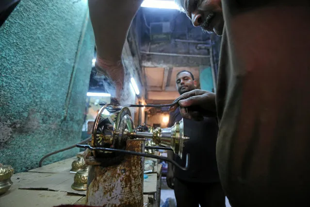 A worker manufacturing primus stoves known as “Bagour” in Arabic, in Cairo, Egypt, May 11, 2016. (Photo by Mohamed Abd El Ghany/Reuters)