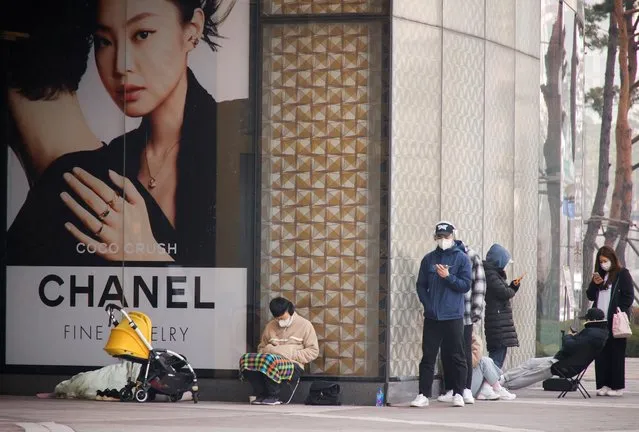 Shoppers line up outside a Chanel store in Seoul, South Korea, March 16, 2022. (Photo by Heo Ran/Reuters)