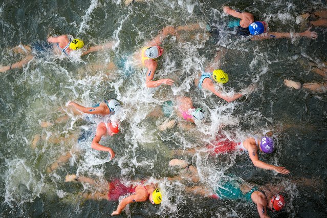 Australia's Natalie Van Coevorden, center, competes in the swim leg of the women's individual triathlon competition at the 2024 Summer Olympics, Wednesday, July 31, 2024, in Paris, France. (Photo by David Goldman/AP Photo)