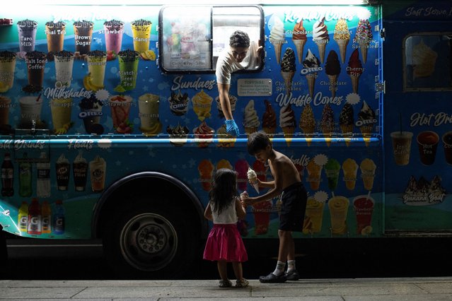 Children hold ice cream near a food truck vendor at the National Mall in Washington, D.C., U.S., August 12, 2024. (Photo by Kaylee Greenlee Beal /Reuters)