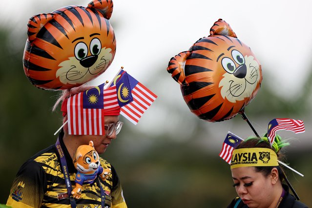 Malaysian supporters attend badminton at Morodok Techo Badminton Hall in Phnom Penh, Cambodia on May 10, 2023. (Photo by Chalinee Thirasupa/Reuters)