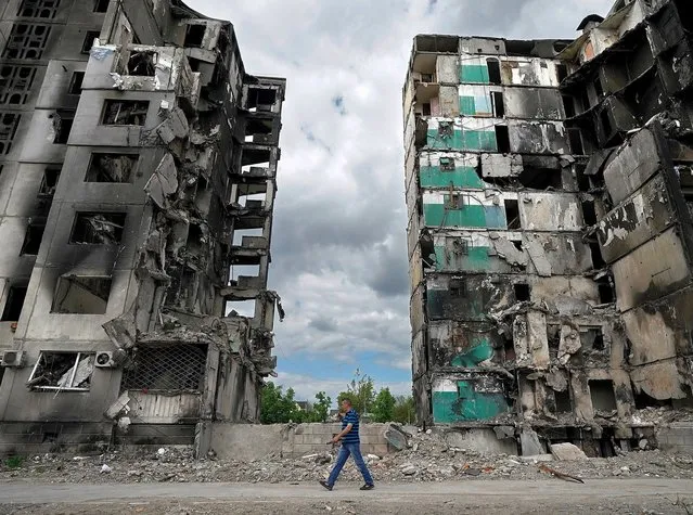Bombed buildings wait to be demolished as essential services and people begin to return to the town of Borodianka oon May 15, 2022 in Borodianka, Ukraine. As Russia concentrates its attack on the east and south of the country, residents of the Kyiv region are returning to assess the war's toll on their communities. The towns around the capital were heavily damaged following weeks of brutal war as Russia made its failed bid to take Kyiv. (Photo by Christopher Furlong/Getty Images)