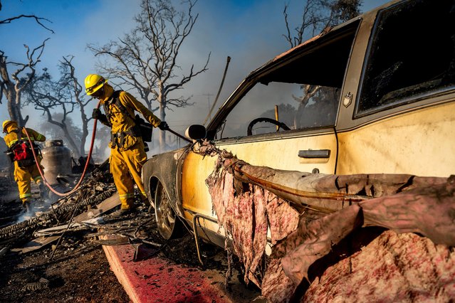 Firefighters extinguish hot spots as the Boyles fire burns in Clearlake, Calif., on Sunday, September 8, 2024. (Phoot by Noah Berger/AP Photo)