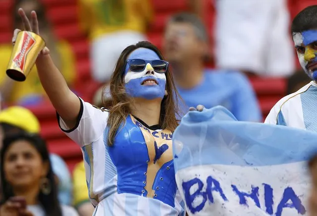 An Argentina fan cheers before the 2014 World Cup quarter-finals between Argentina and Belgium at the Brasilia national stadium in Brasilia July 5, 2014. (Photo by Dominic Ebenbichler/Reuters)